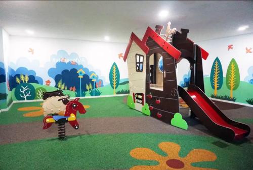 a childs room with a play area with a toy house at Vista Alam 3 bedroom in Shah Alam