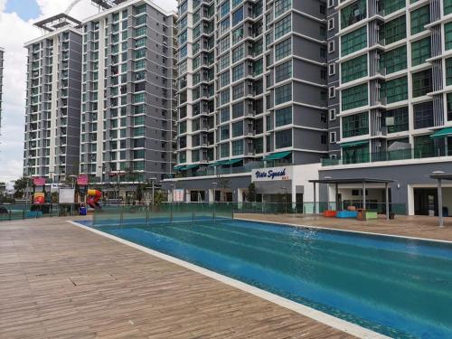 a swimming pool in front of some tall buildings at Vista Alam 3 bedroom in Shah Alam