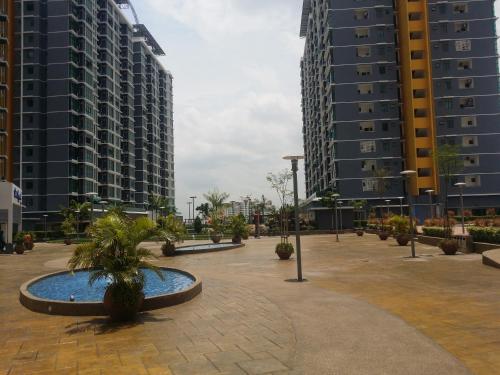 a courtyard in a city with tall buildings at Vista Alam 3 bedroom in Shah Alam
