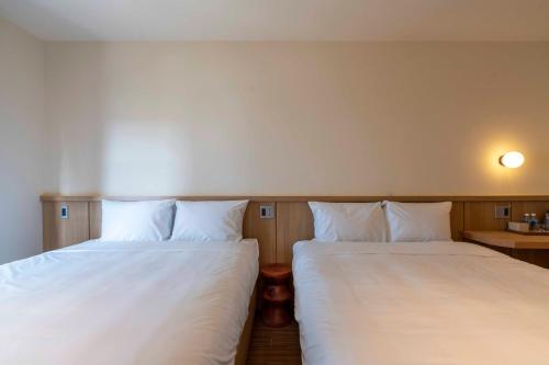 two beds sitting next to each other in a room at DP Hotel in Tây Ninh