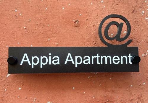a sign that says apula appointment hanging on a wall at Appia Apartment - Camera Trifoglio in Santa Maria a Vico