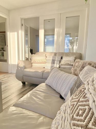 a living room with a white couch at Seaview Cottage on the Island in Millbay
