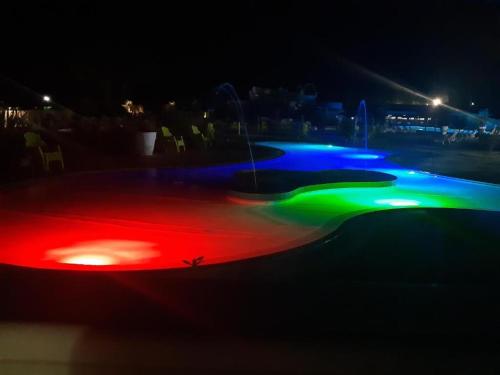 a skateboard park at night with colored lights at Mobil Home Moderne de 40m2 TOUT CONFORT Camping SIBLU Les CHARMETTES 785 La Palmyre Les Mathes in Les Mathes