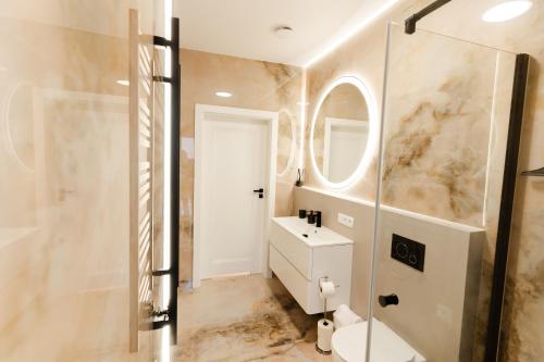 a bathroom with a sink and a mirror at Flora & Sauna Kamieńczyk Konwaliowa 8 in Błonie