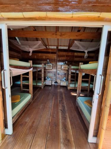 a room with four bunk beds in a cabin at Koalama Cambodia in Koh Rong Sanloem