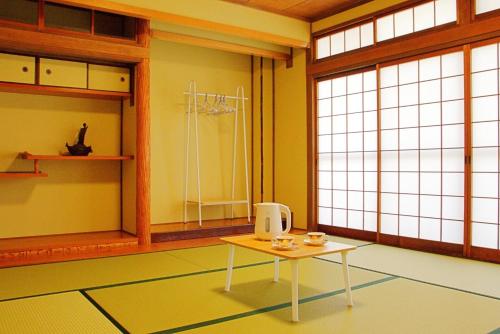 a room with a table in front of a window at Guest House Orange no Kaze - Vacation STAY 01302v in Imabari