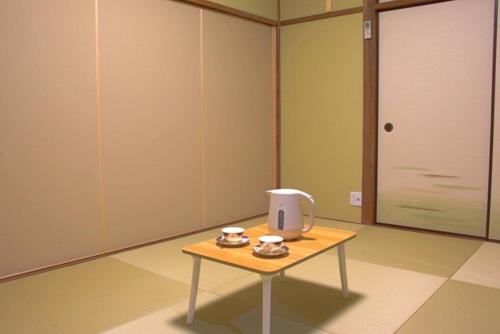 a room with a table with a radio on it at Guest House Orange no Kaze - Vacation STAY 01298v in Imabari