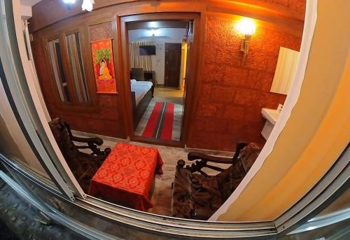 a view of a living room with a table and chairs at Makam Holiday Home in Iritti