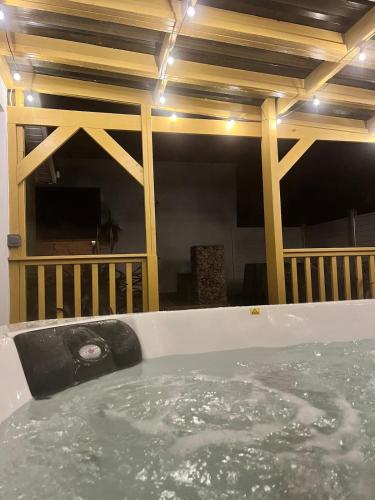 a jacuzzi tub in the middle of a room at Heirloom Lodge in Ballina