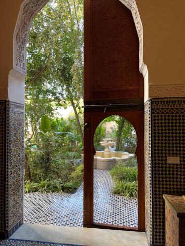 an open door to a courtyard with a fountain at Riad Hanael Garden & Spa in Fès