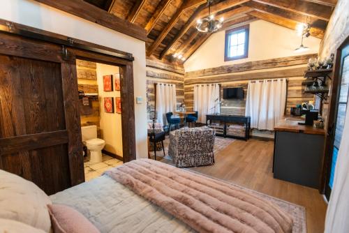 a bedroom with a bed and a living room at Barnwood Village in White Sulphur Springs