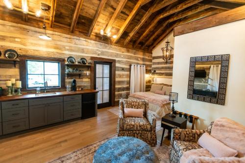 a kitchen and living room with wooden walls at Barnwood Village in White Sulphur Springs