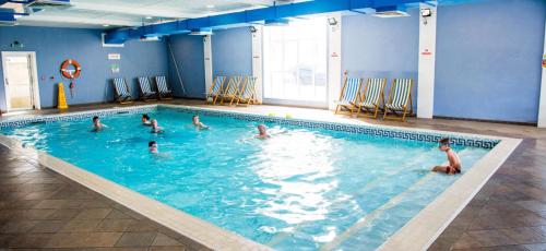a group of people in a swimming pool at Sea View Escape 2 Bedroom Pet Friendly Caravan at Clarach Bay Gm3 in Aberystwyth