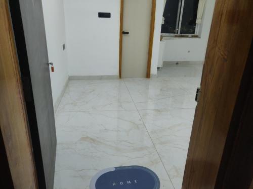 a hallway with a tile floor with a blue scale on it at Bhoomi mansion Apartment 23 in Bhubaneshwar