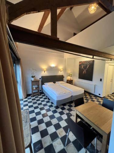 a bedroom with a bed and a checkered floor at Landgoed Palingbeek in Ypres