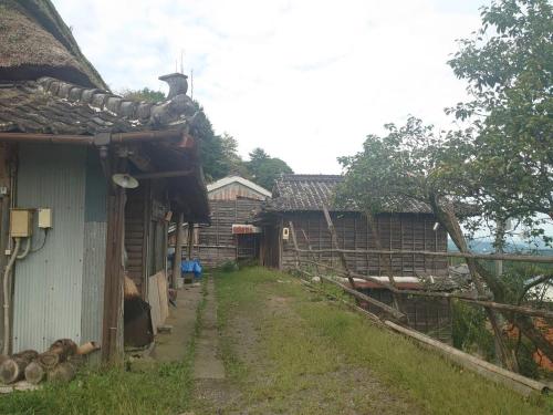 a dirt road next to a house and a fence at Kekanosato Kojyo - Vacation STAY 33013v in Sadamitsu
