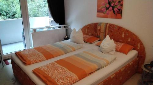 a couple of beds sitting in a room at Ferienperle-Bad-Harzburg-mit-Schwimmbad-und-Sauna in Bad Harzburg