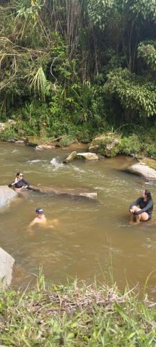 a group of people swimming in a river at HOSPEDAJE MARIN in Concepción