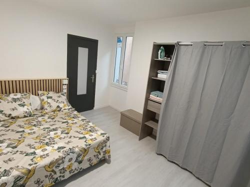 a bedroom with a bed and a dresser in it at Cosy apartment in Vallauris in Vallauris