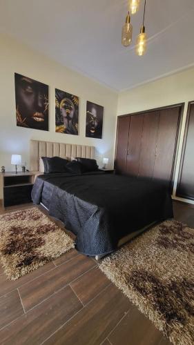 a bedroom with a large bed with two rugs at Cité Marine in Mansouria