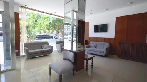 a lobby with couches and chairs in a building at Hotel Bertiami in Mar del Plata