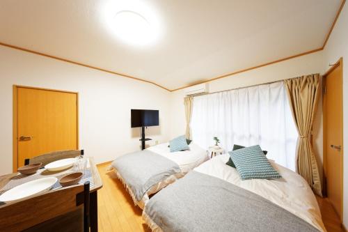 a room with two beds and a sink in it at minpaku Blanco Honjin - Vacation STAY 18357 in Nagoya