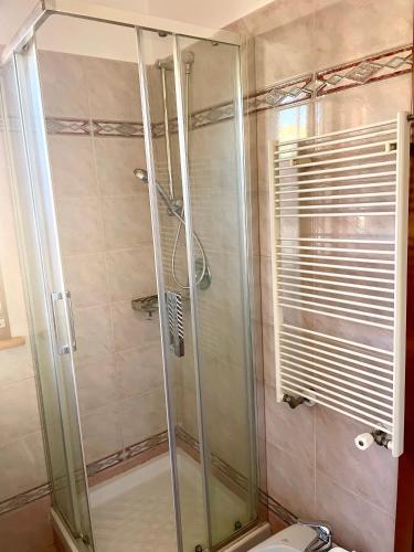 a shower with a glass door in a bathroom at Vacanze Romane LB&C in Rome