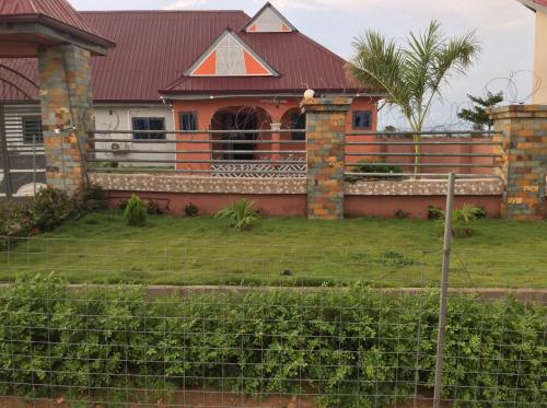 a house with a fence in front of it at RockView Hotel in Tongo