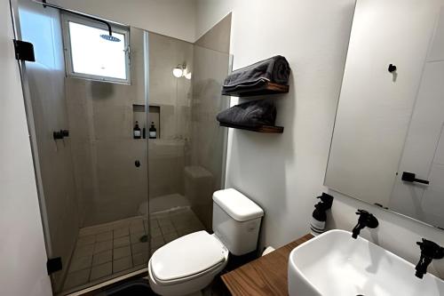 a bathroom with a shower and a toilet and a sink at Country Club en Capala in Chapala