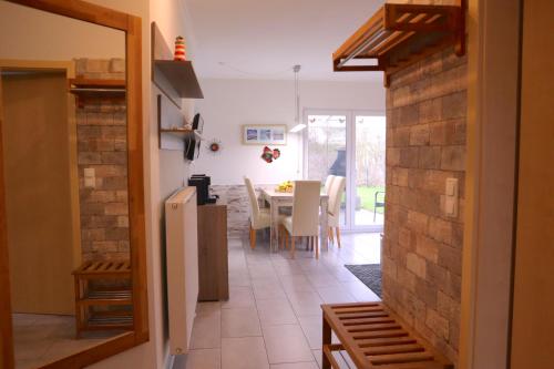 a kitchen and dining room with a table and chairs at Villa am Meer - Antje in Dorum Neufeld