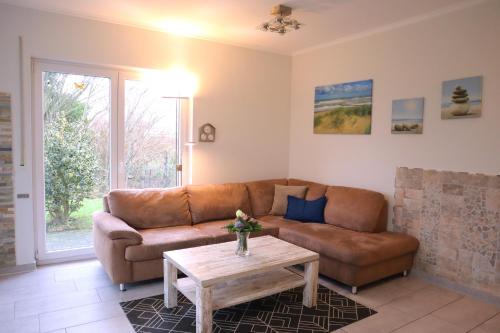 a living room with a couch and a coffee table at Villa am Meer - Antje in Dorum Neufeld