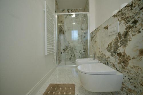 a white bathroom with a toilet and a shower at Affittacamere Ca' Cini in Monselice