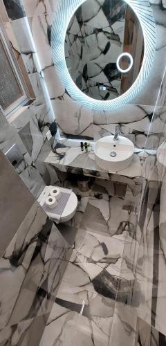 a bathroom with a sink and a mirror at Filio Guesthouse in Kipri