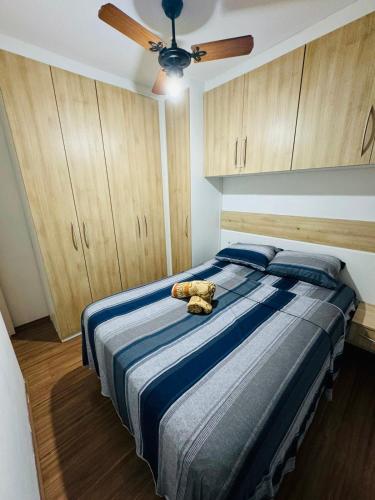 a teddy bear laying on a bed in a bedroom at Aeroporto de Guarulhos 3 in Guarulhos