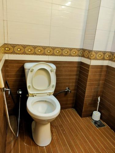 a bathroom with a toilet with a hose at Private & Cozy 2-Bedroom Full Apartment for Families E11 Islamabad in Islamabad