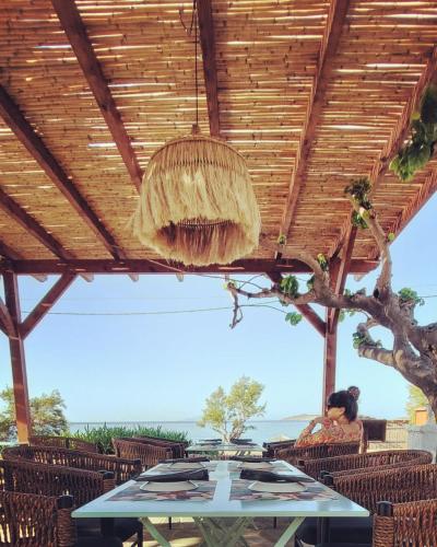 a dining room with a wooden ceiling and a table at Filio Guesthouse in Kypri
