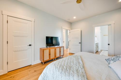 a bedroom with a bed and a flat screen tv at Lakeside Home Near Mammoth Cave and Nolin Lake! in Cub Run