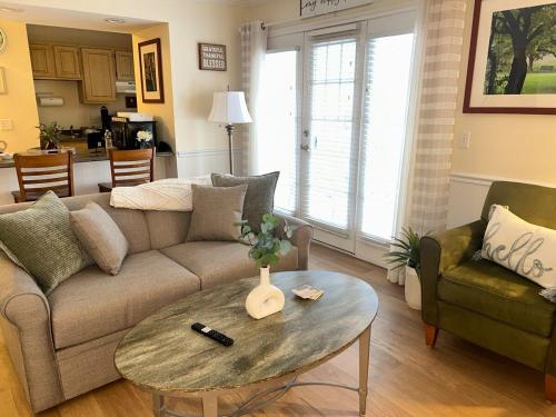 a living room with a couch and a table at Peaceful Oasis steps from Mohegan Sun in Norwich