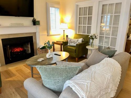 a living room with a couch and a fireplace at Peaceful Oasis steps from Mohegan Sun in Norwich