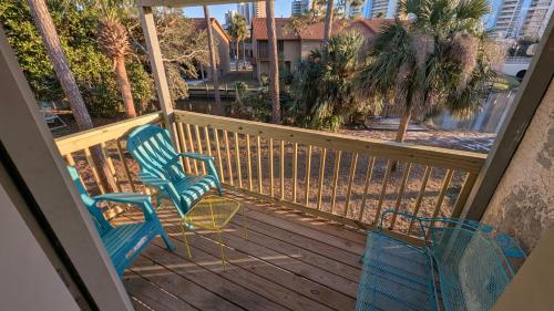 two chairs sitting on a deck with a view at Double Take! Renovated Vacation Home in Panama City Beach