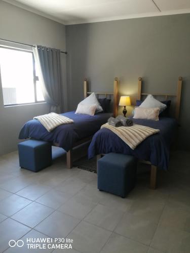 a bedroom with two beds and a window at Casablanca B&B in Beaufort West
