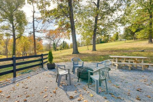a group of chairs and tables in a park at Loretto Cottage on Bourbon Trail with Fire Pit in Loretto