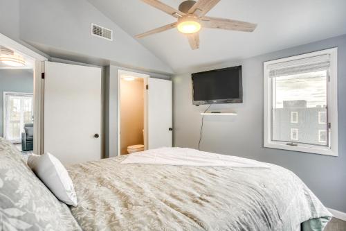 a bedroom with a bed and a flat screen tv at Renovated Ocean City Retreat - Walk to Beach! in Ocean City