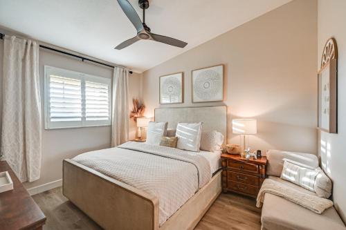 a bedroom with a bed and a ceiling fan at Elegant Naples Condo with Golf View and Community Pool in Naples
