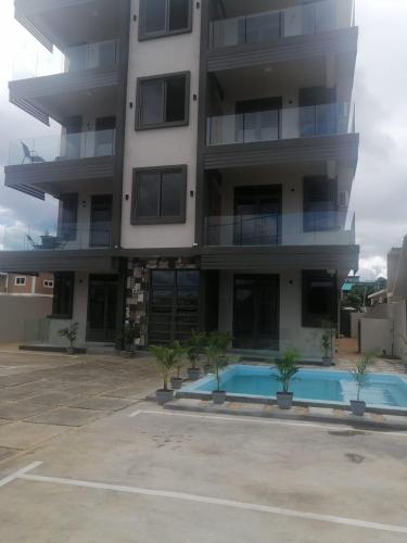 an apartment building with a swimming pool in front of it at Mauritius Heights in Flic-en-Flac