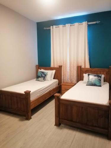 two beds sitting next to each other in a room at Mauritius Heights in Flic-en-Flac