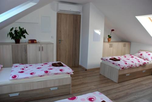a bedroom with two beds and a staircase at Apartmán Na Sluneční Valtice in Valtice