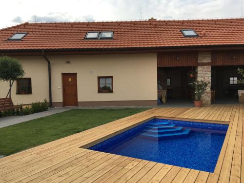 a house with a swimming pool in the yard at Apartmán Na Sluneční Valtice in Valtice