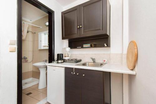 a small bathroom with a sink and a toilet at Saint Michel Apartments in Rhodes Town