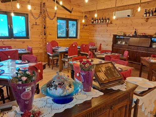 a dining room with tables and red chairs at Villaggio Turistico Tecciù di Cuppi in Magliolo